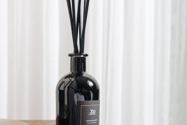 black glass bottle on brown wooden table