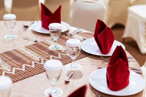 selective focus photography of red table napkins on white plates